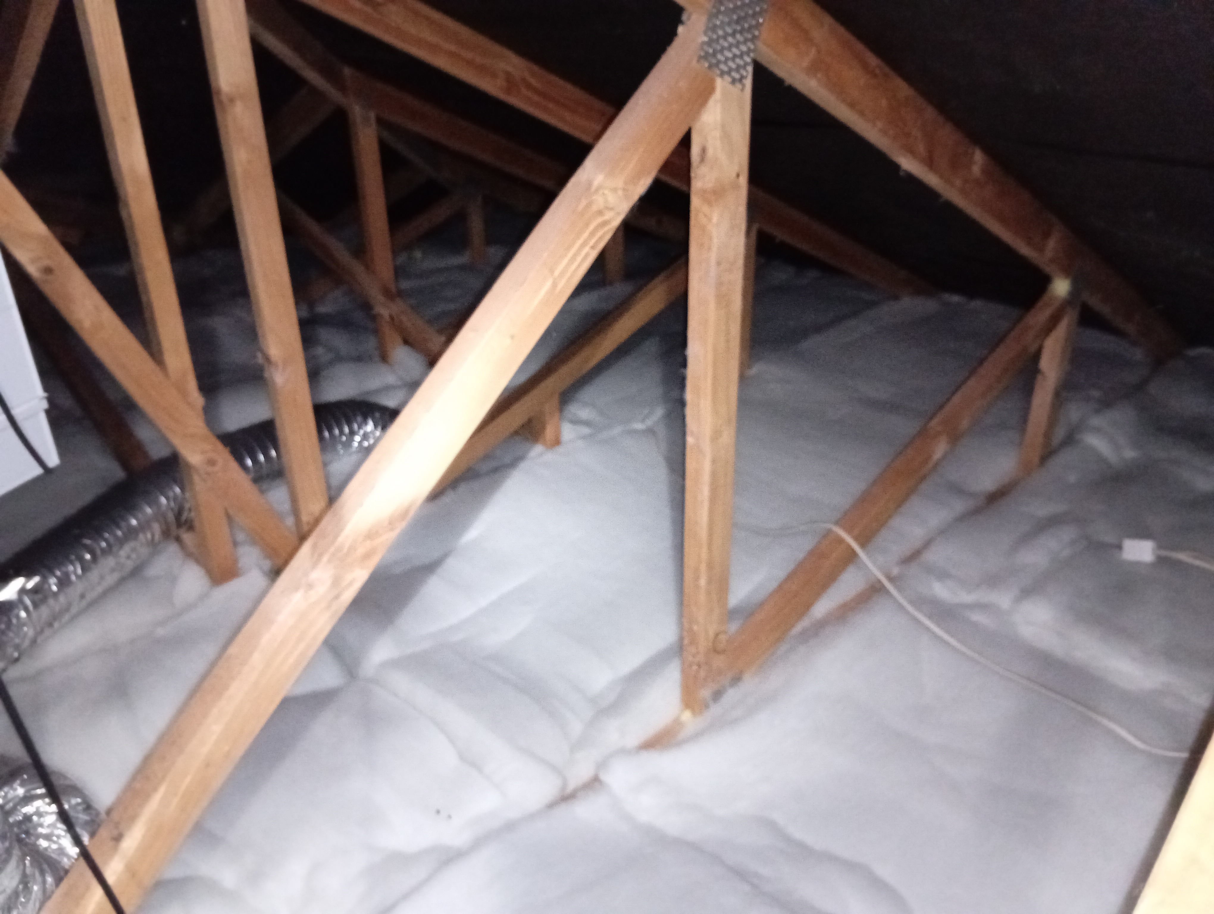 Insulation laid across a ceiling cavity
